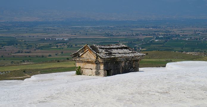 Steingrab von Kalk eingeschlossen in Pamukkale. Mit Blick auf das Tal von den Kalkterrassen aus.