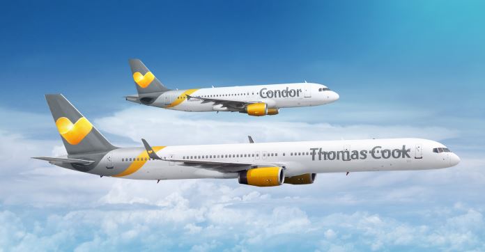 (Condor) Zwei Flugzeuge on gelb-grauer Farbe in der Luft. Eines ist groß mit "Thomas Cook" und ein Flugzeug mit "Condor" beschrieben.