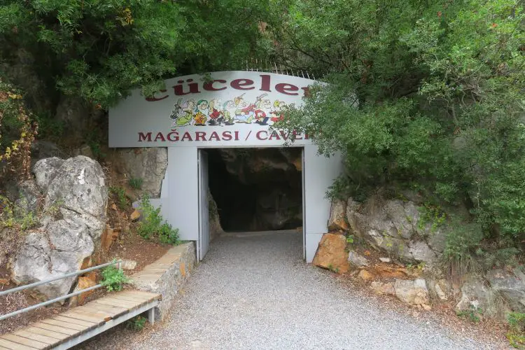 Der Eingang zur Dwarfs Cave mit dem Namen der Höhle in roten Buchstaben und Zwergenfiguren. 