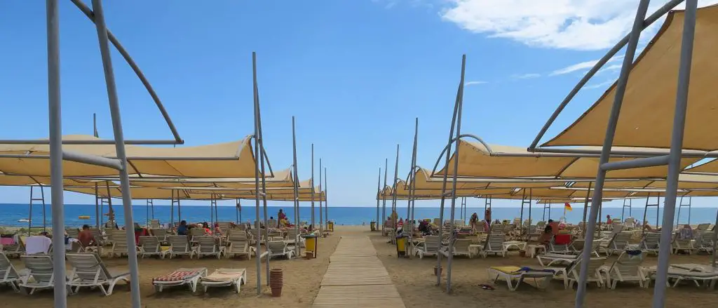 Strand von Konakli in der Türkei, mit Liegestühlen und Sonnenschirmen.